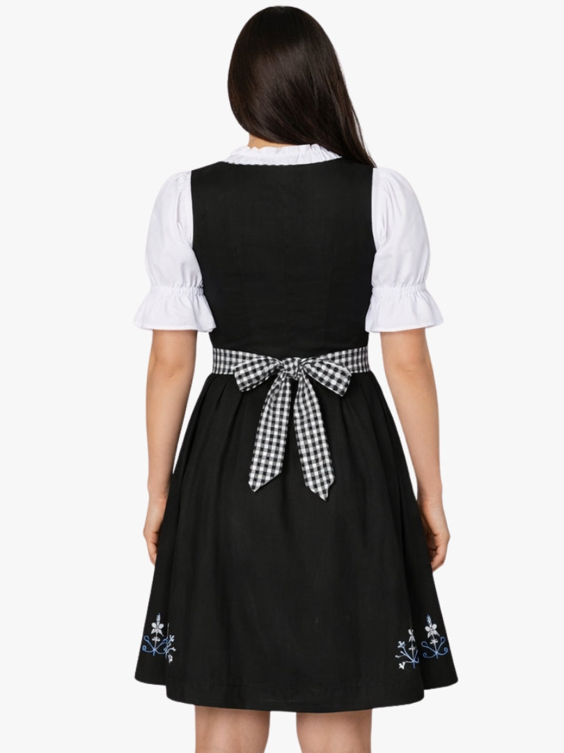 Front view of women's traditional black dirndl dress with white blouse, black bodice detailing, and black-and-white checkered apron.