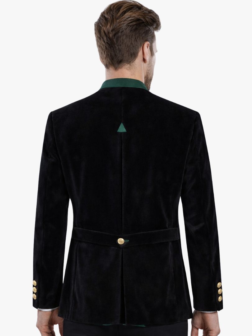 Man wearing black velvet Bavarian Trachten jacket with green collar and gold buttons