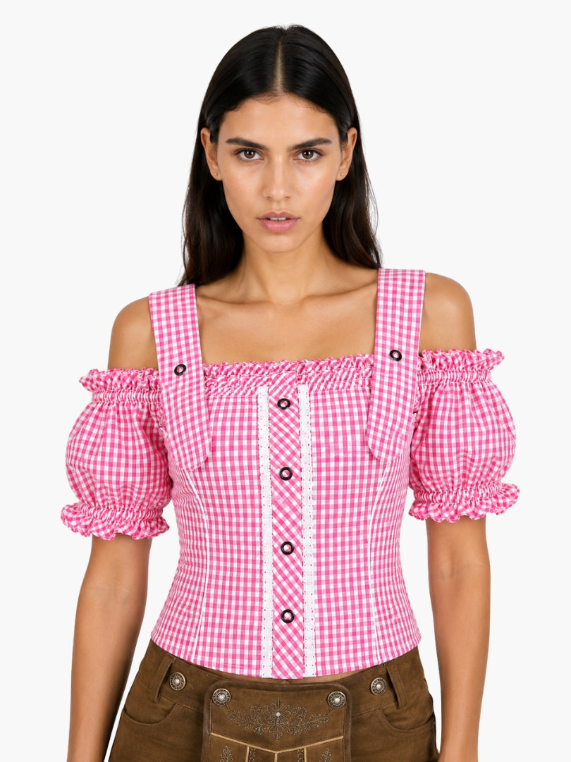 Women’s pink gingham Oktoberfest blouse with puff sleeves, lace trim, and traditional Bavarian styling paired with lederhosen.