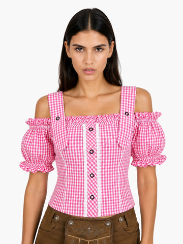 Women’s pink gingham Oktoberfest blouse with puff sleeves, lace trim, and traditional Bavarian styling paired with lederhosen.