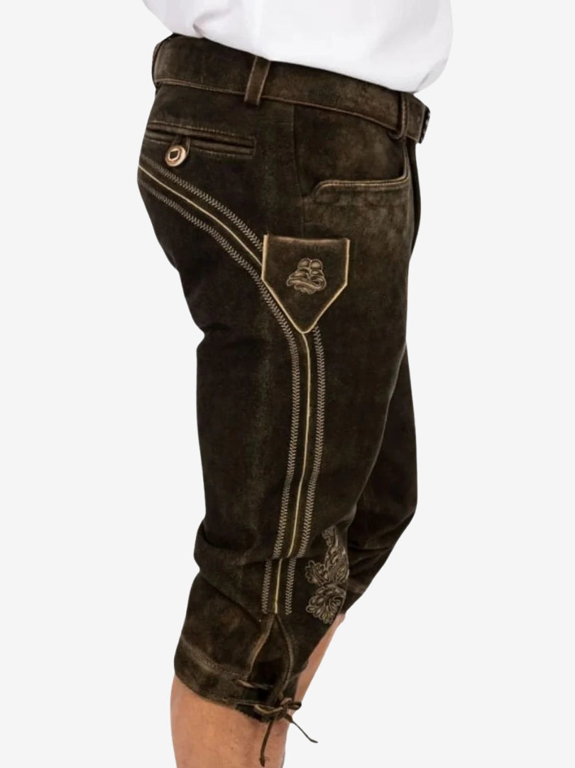 Side view of dark brown bundhosen showing embroidered panel, pocket detail, and knee-length fit with lace ties.