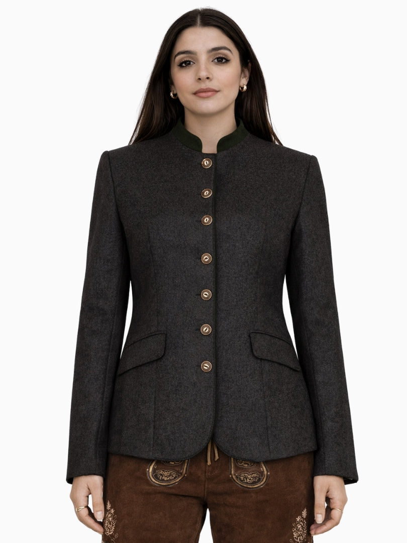 Women’s charcoal Bavarian Trachten jacket with green stand collar, traditional metal buttons, and tailored fit, paired with brown lederhosen shorts, front view.