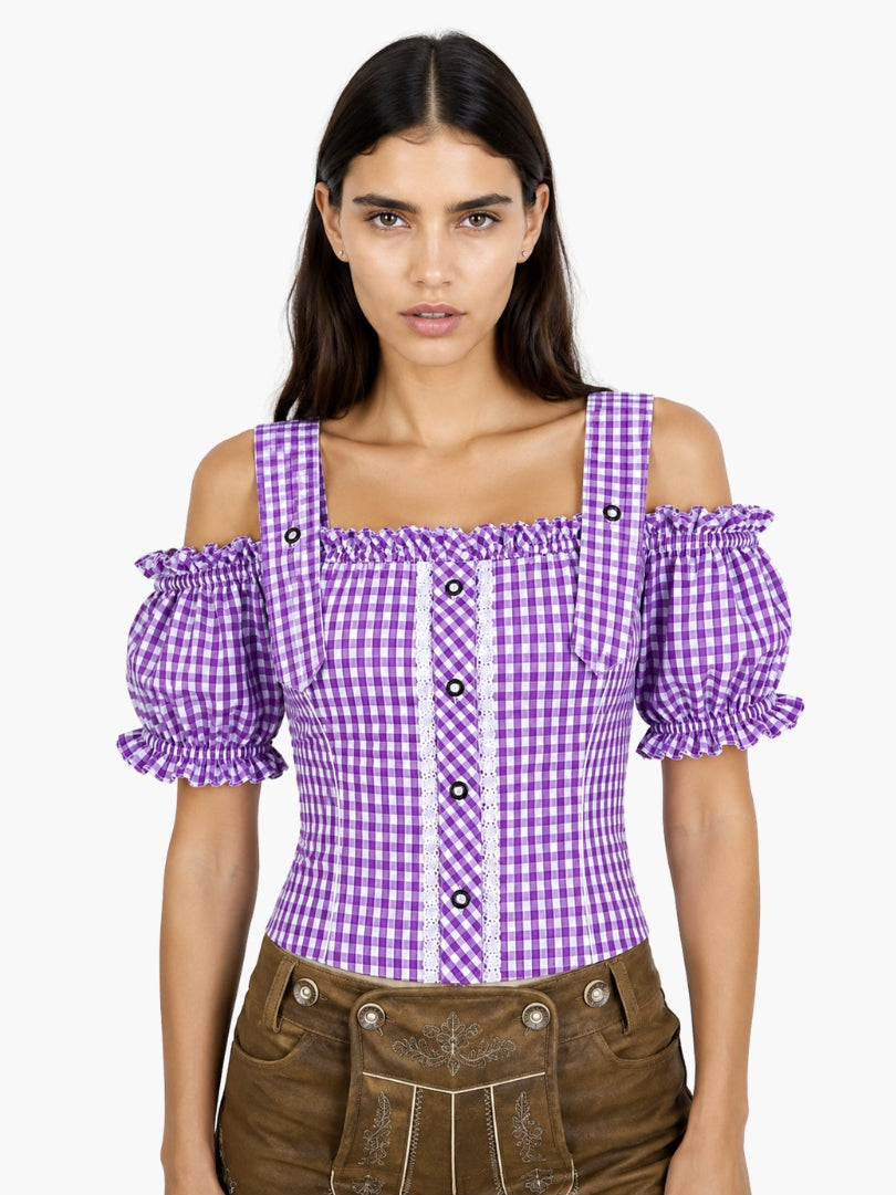 Women’s purple gingham Oktoberfest blouse with puff sleeves, lace panel detail, and fitted bodice paired with traditional lederhosen.