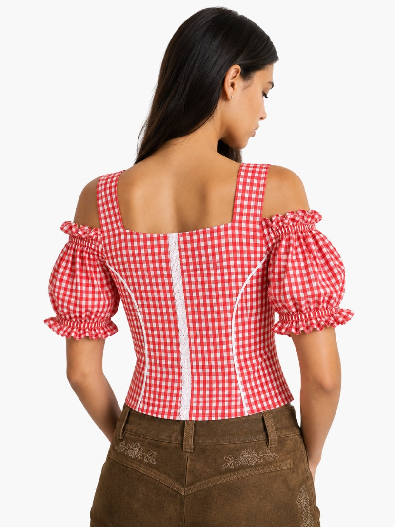 Back view of women’s red gingham Oktoberfest blouse with puff sleeves, fitted waist, and traditional Bavarian styling paired with lederhosen.