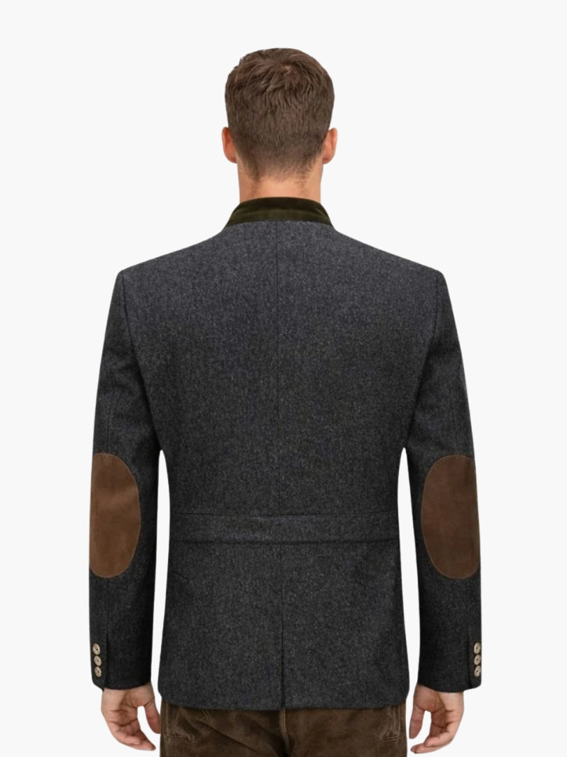 Back view of dark grey Bavarian Trachten jacket with green velvet collar and brown elbow patches for traditional Alpine style.