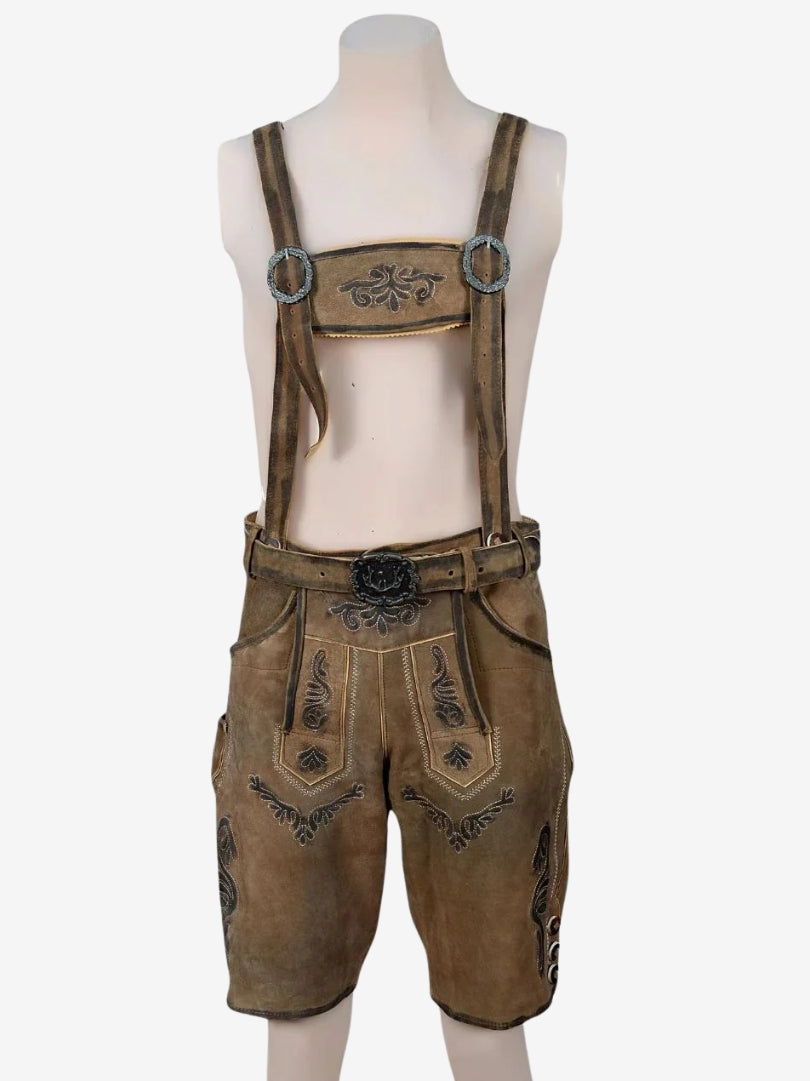 Man wearing brown lederhosen with suspenders and embroidery, paired with a white shirt and traditional belt.