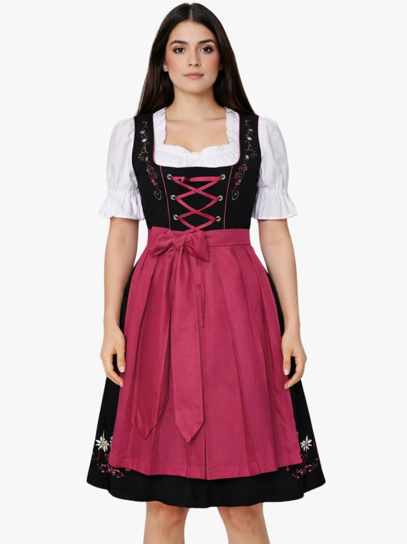 Front view of women's black Bavarian dirndl dress with white puff sleeve blouse, pink lace-up bodice, and pink apron.
