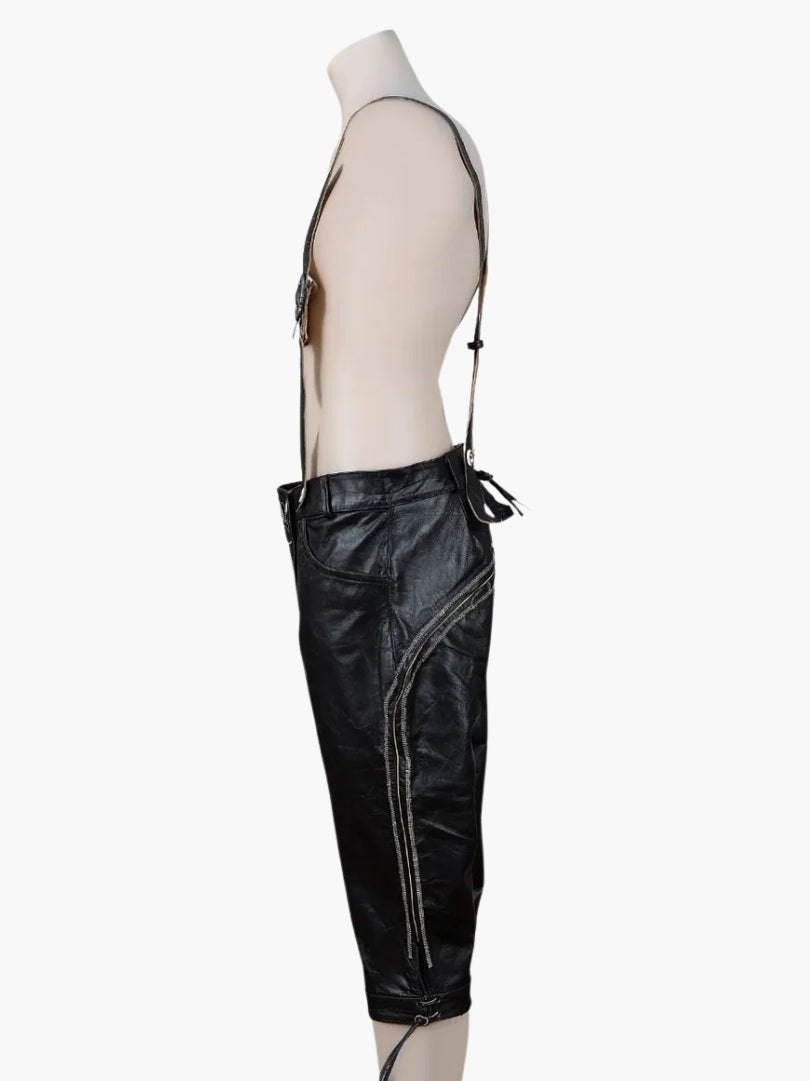Side profile of black bundhosen with suspenders showing stitched side detailing, utility pocket, and knee-length cut with lace-up hem.