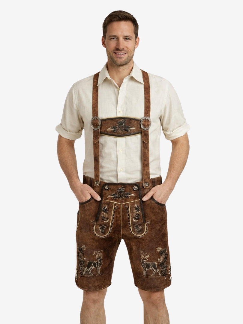Man wearing traditional Bavarian lederhosen with a white shirt on a white background