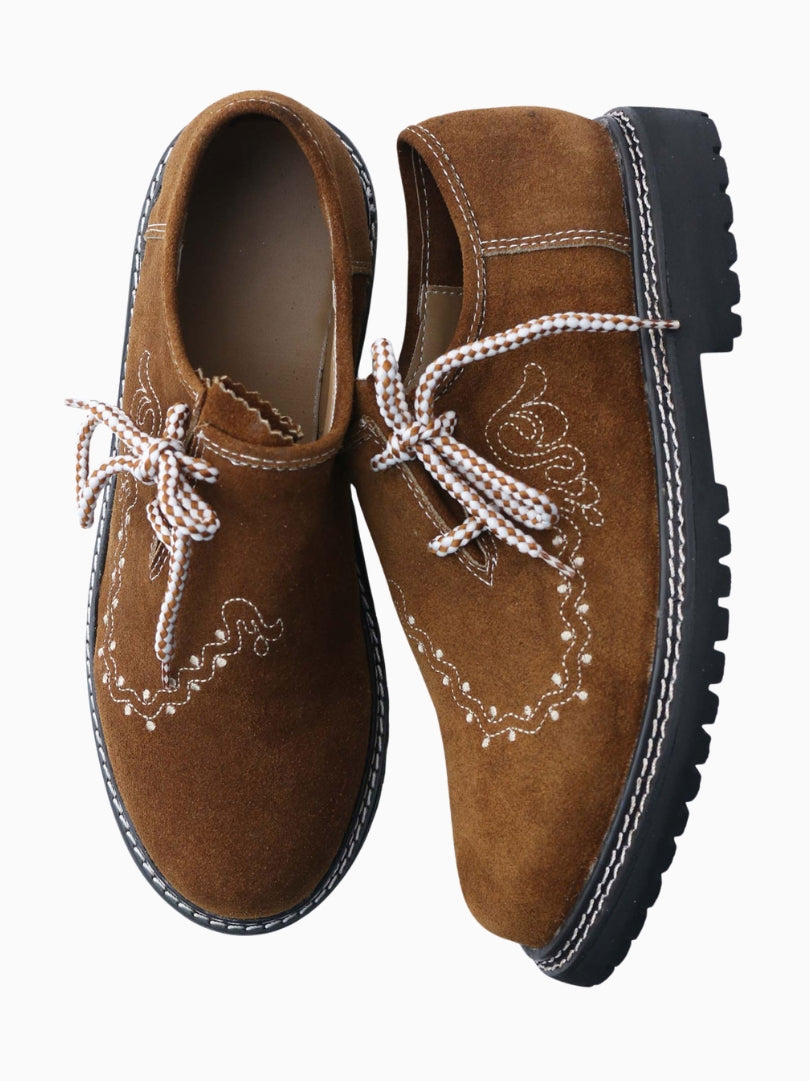 Top view of brown suede Oktoberfest Trachten shoes with decorative embroidery and patterned laces.