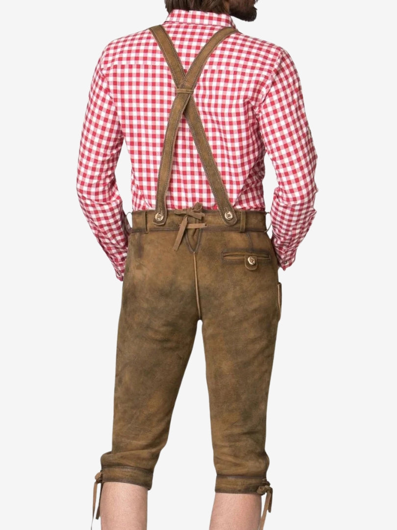 Back view of brown bundhosen with crossed suspenders and red checkered shirt, featuring rear pocket and adjustable waistband.