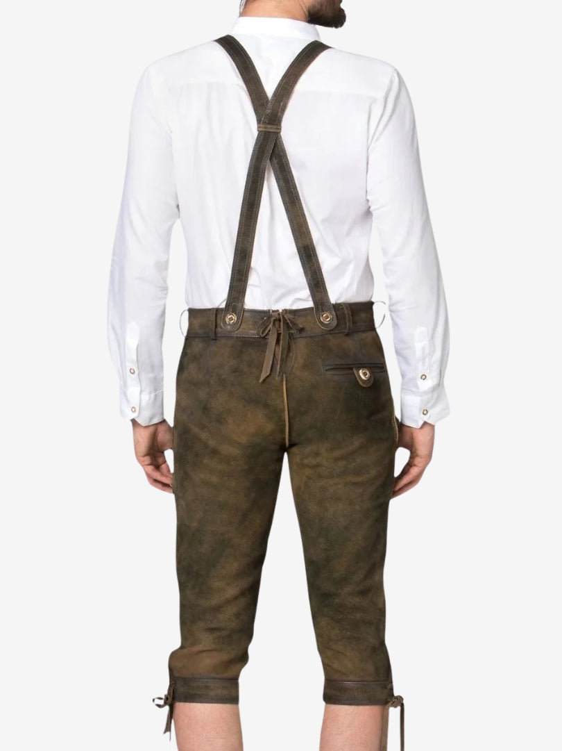 Back view of brown bundhosen with crossed suspenders, showing adjustable waistband and rear pocket detail.
