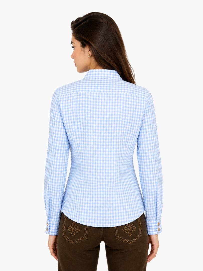 Women’s timeless checked shirt in light blue pattern with button front and rolled sleeves, styled with traditional lederhosen.