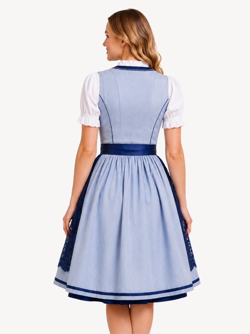 A woman shown from the back wearing a light blue and navy traditional German dirndl dress with a white short-sleeve blouse underneath, against a plain off-white background.