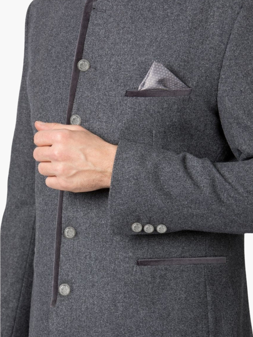 Close-up of grey Trachten jacket featuring metal buttons, contrast trim, and pocket square detail in traditional Alpine design.