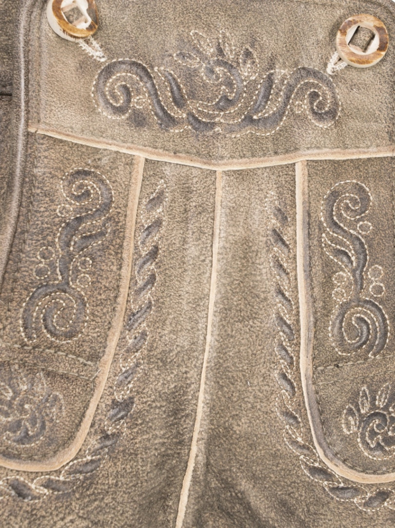 Traditional Bavarian lederhosen with embroidery on a white background