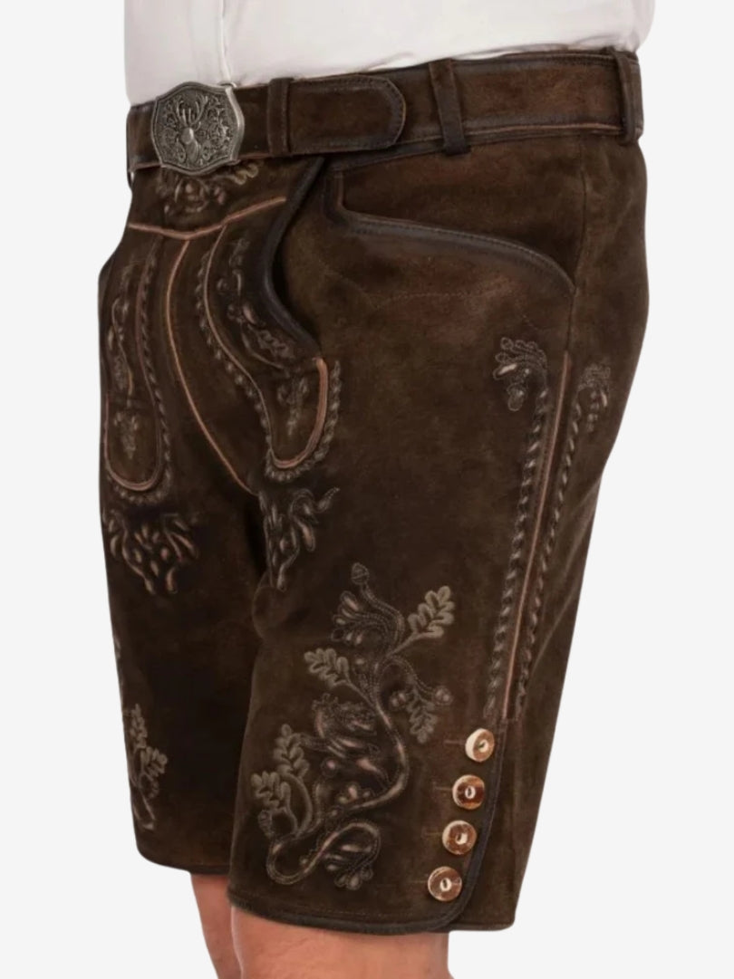 Right-side perspective of dark brown lederhosen with stitched detailing, embroidery, and button accents near the hem.