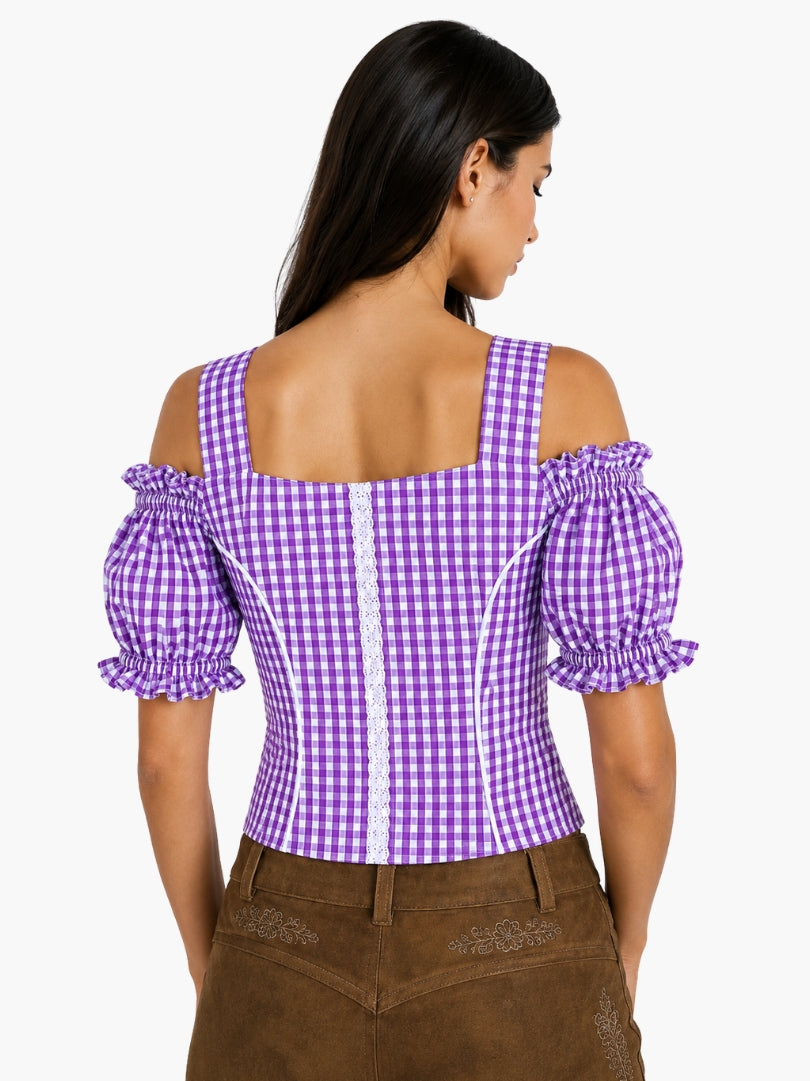 Women’s purple gingham Oktoberfest blouse with puff sleeves, lace panel detail, and fitted bodice paired with traditional lederhosen.