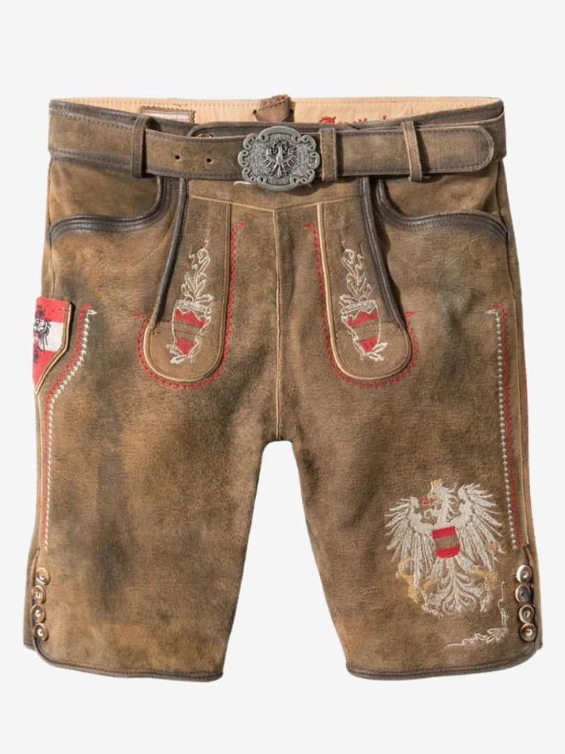 Front view of a man wearing brown lederhosen with red and white embroidery, paired with a white shirt and decorative belt.