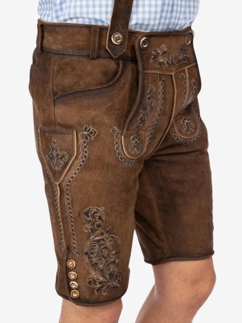 Side view of brown embroidered lederhosen showing decorative stitching, side pocket, and traditional buttons along the leg.