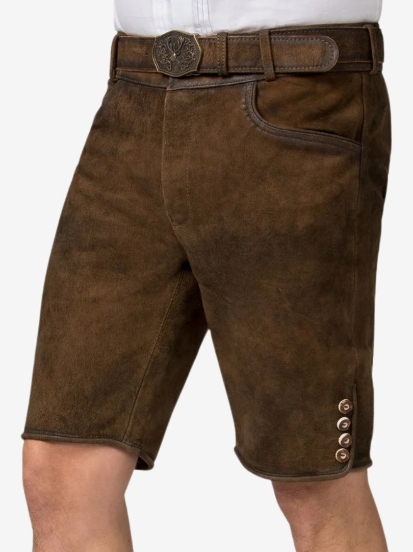 Angled front view of plain brown lederhosen highlighting clean stitching, front pockets, and decorative side buttons near the hem.