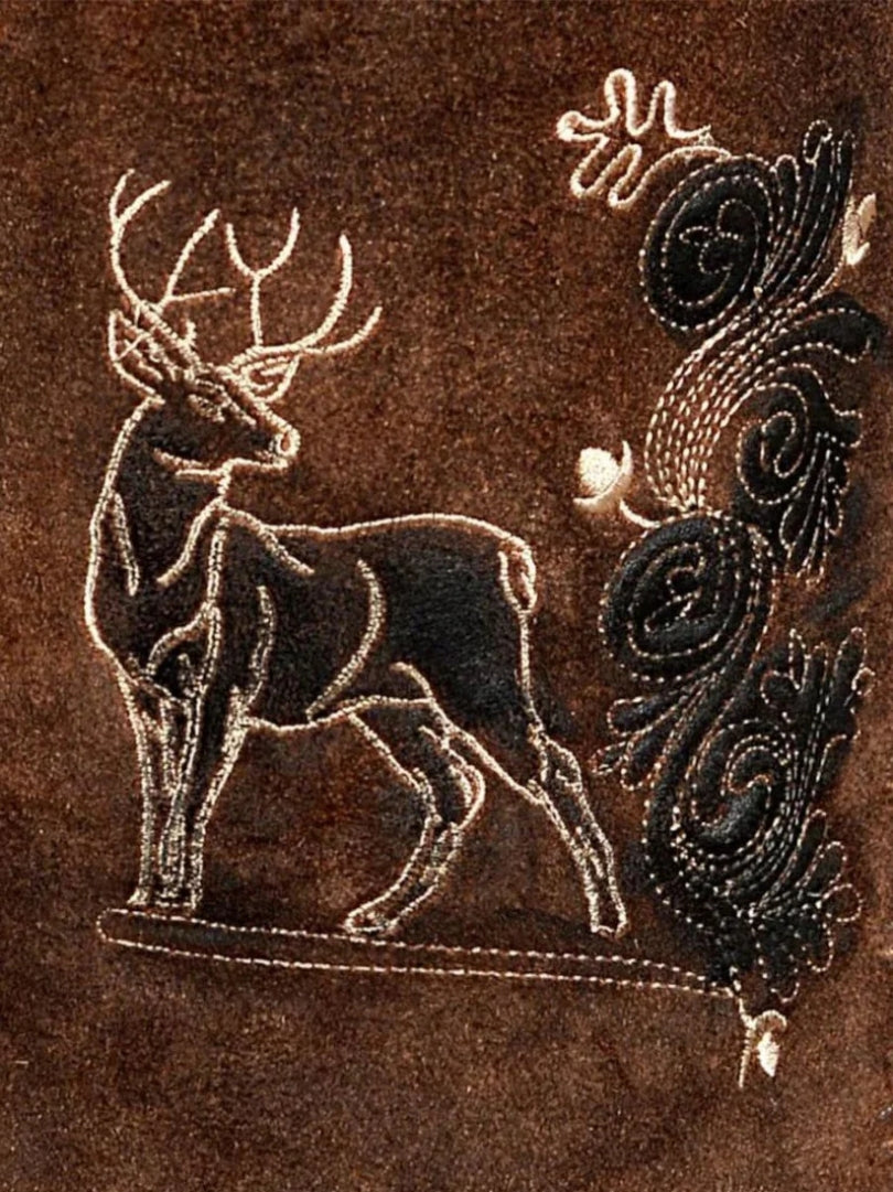 Close-up of deer embroidery and decorative stitching on brown suede lederhosen.