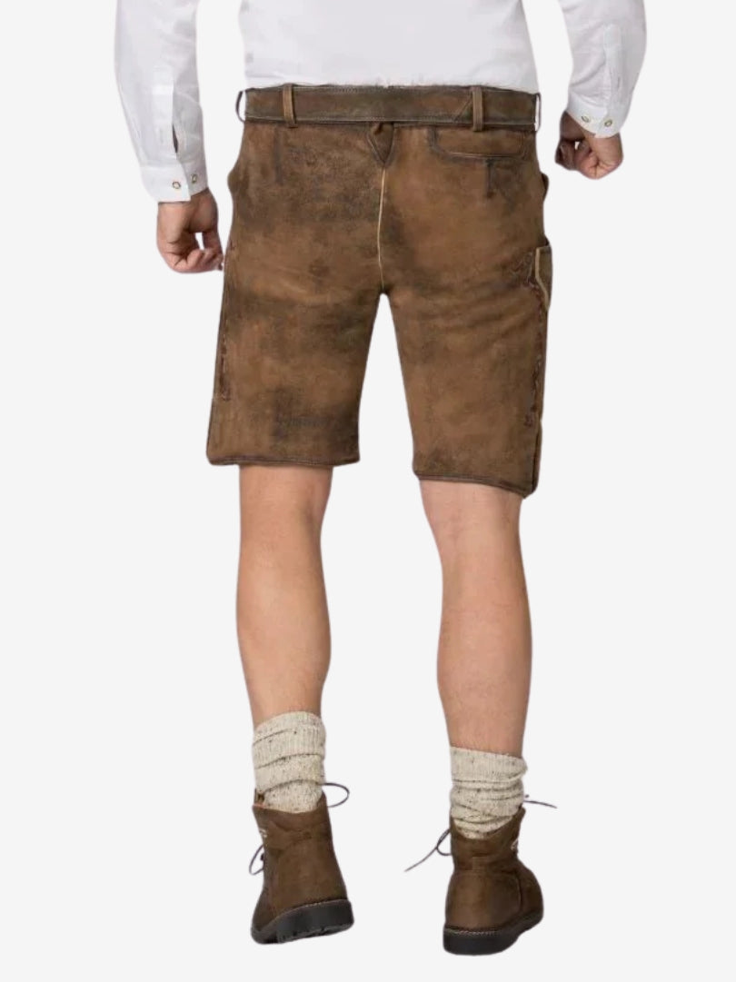 Rear view of brown lederhosen with a smooth suede finish, back pocket detail, and traditional styling, worn with wool socks and brown shoes.