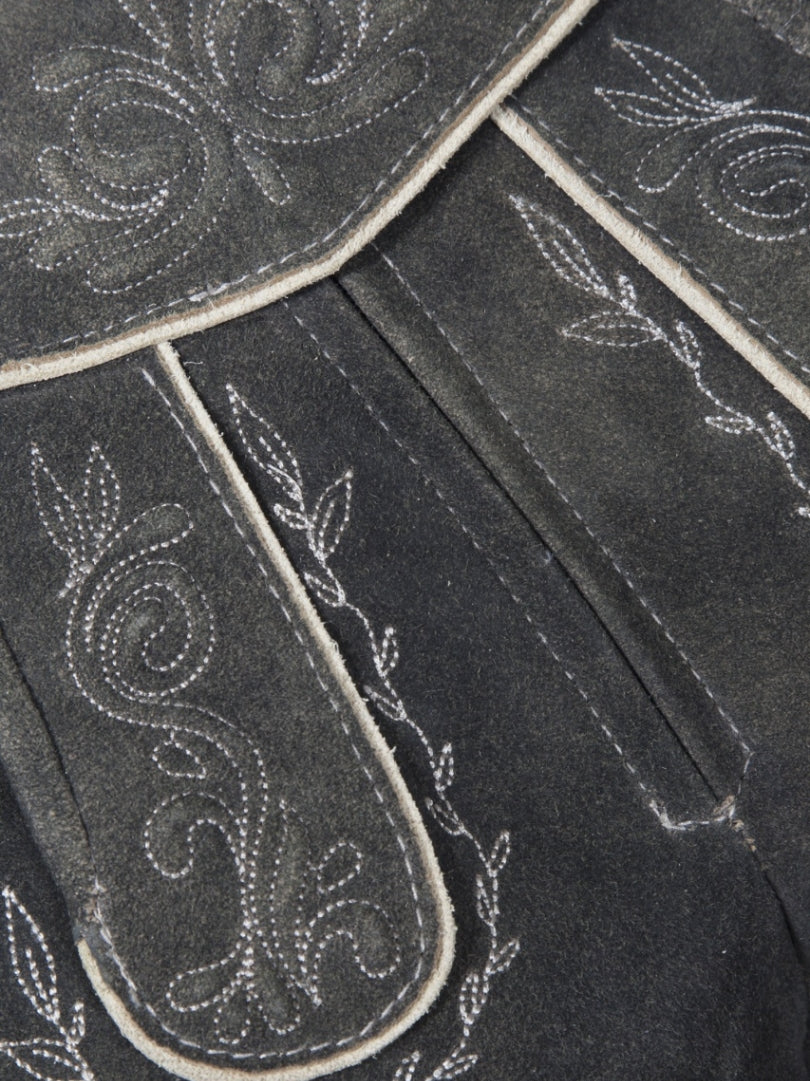 Front angled view of charcoal grey traditional lederhosen-style shorts featuring embroidered patterns, decorative front flap with buttons, and contrast piping.