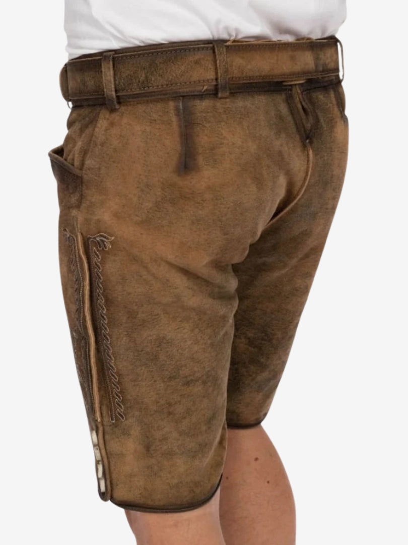 Side view of tan lederhosen showing pocket detail, belt loops, and smooth suede texture with light shading.