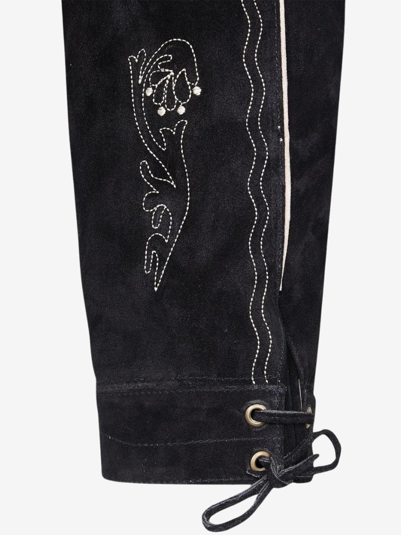 Close-up of leg embroidery with floral design and contrast stitching on black leather.