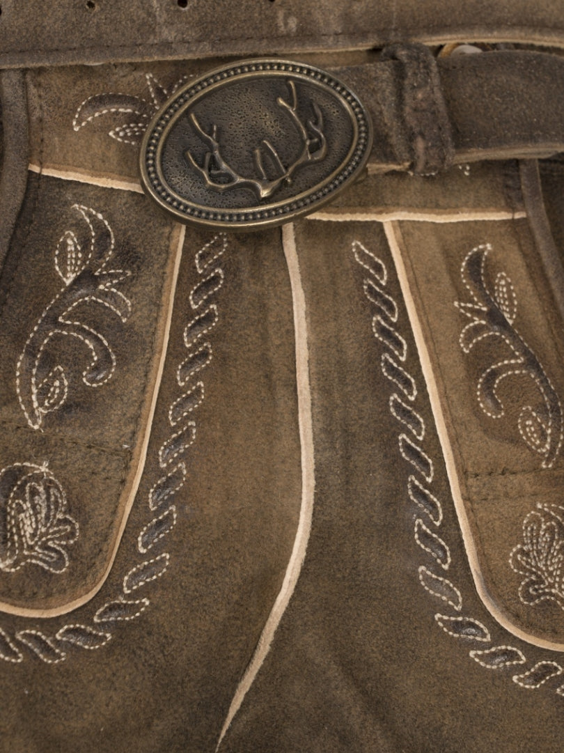 Front view of rustic brown traditional lederhosen-style shorts with embroidered patterns, decorative front flap with buttons, and a vintage suede-like texture.