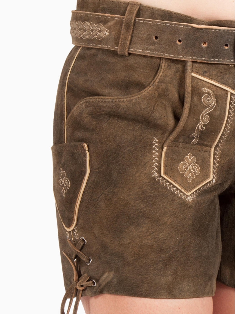 Close-up side view of women's brown suede lederhosen shorts with embroidery and lace-up leg detail