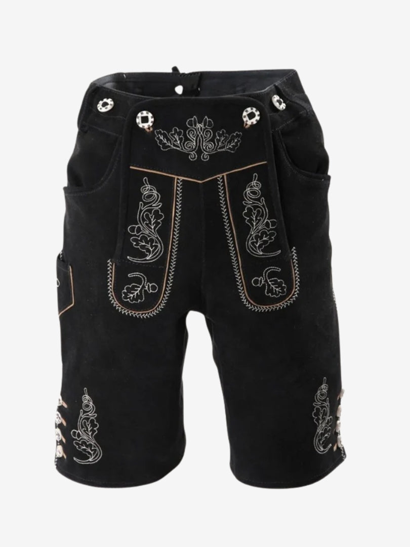 Man wearing a white button-up shirt paired with black embroidered lederhosen shorts, standing against a plain background.