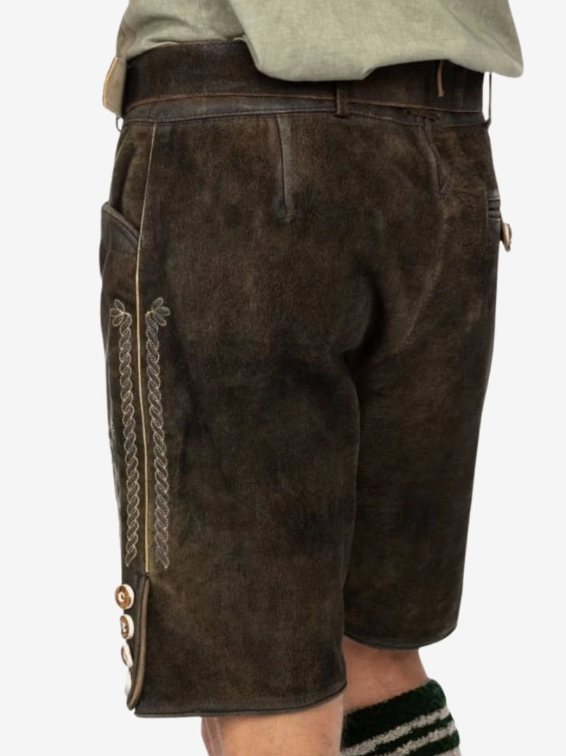 Rear view of dark brown lederhosen featuring a smooth leather finish, back pocket, and subtle stitching details.