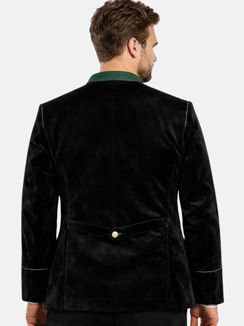 Man wearing black velvet Bavarian Trachten jacket with green trim and bone buttons