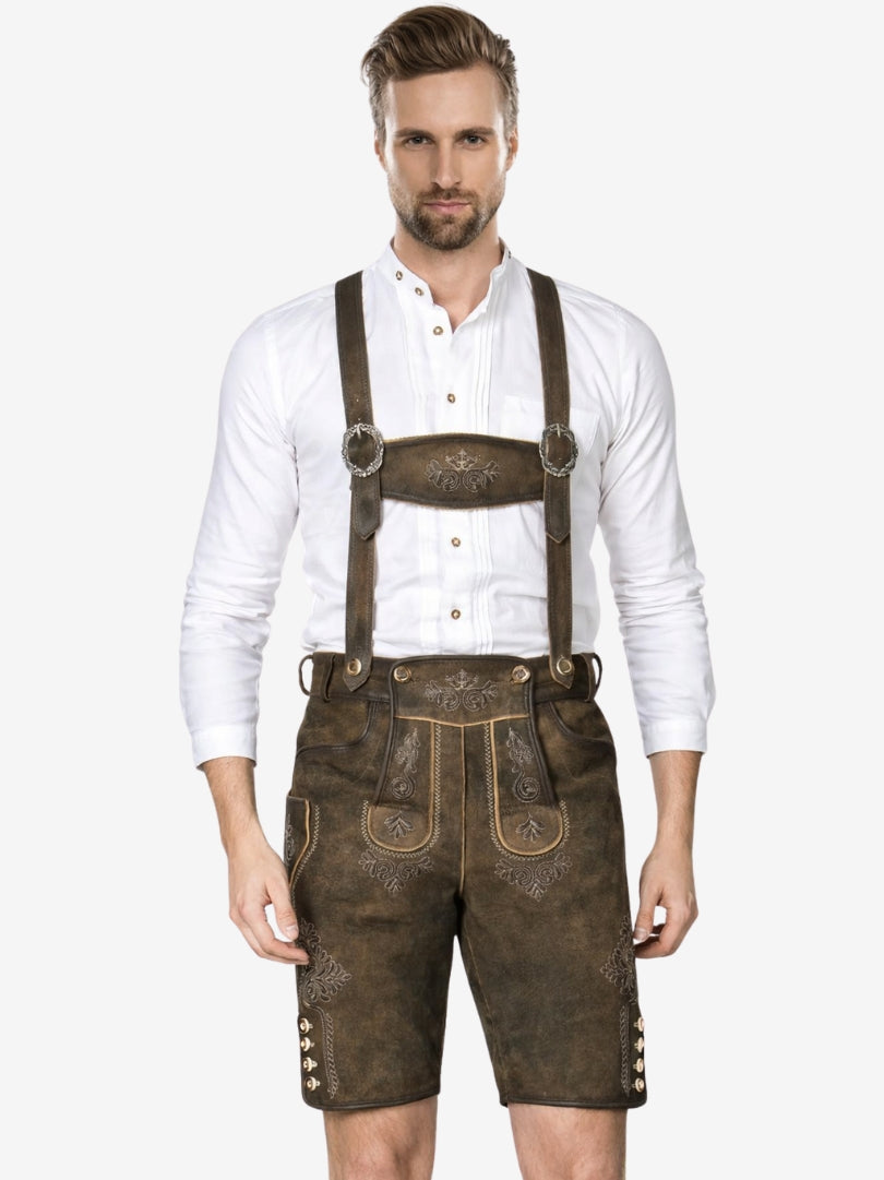 Full front view of man wearing traditional brown lederhosen with suspenders, embroidery, and white shirt.