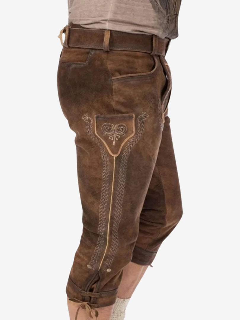 Side view of brown bundhosen highlighting embroidered panel, pocket detail, and adjustable knee ties.