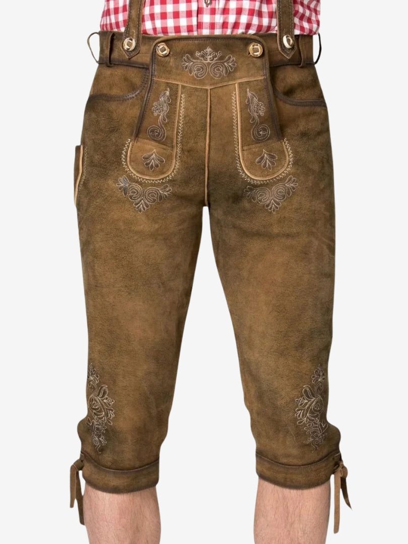 Front close-up of brown bundhosen highlighting detailed embroidery on the front panel and thigh areas.
