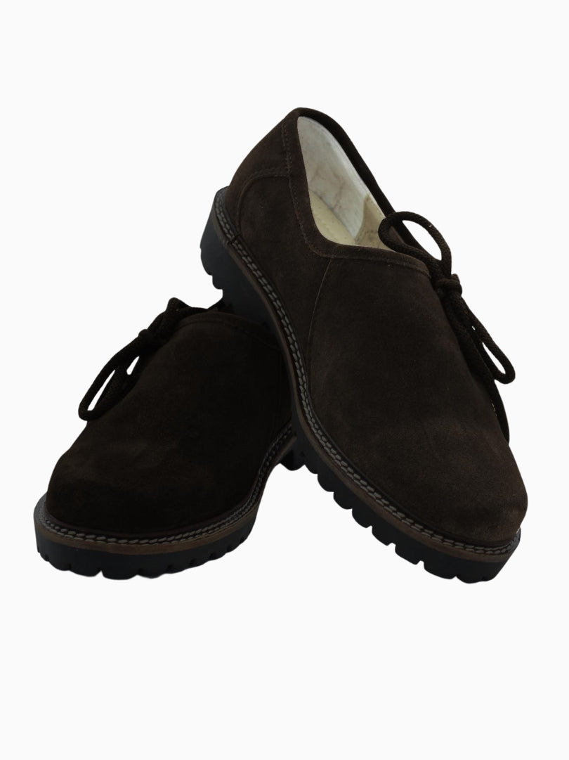 Pair of dark brown suede traditional Trachten shoes with lace-up front, round toe design, and thick black rugged sole, displayed on a white background.
