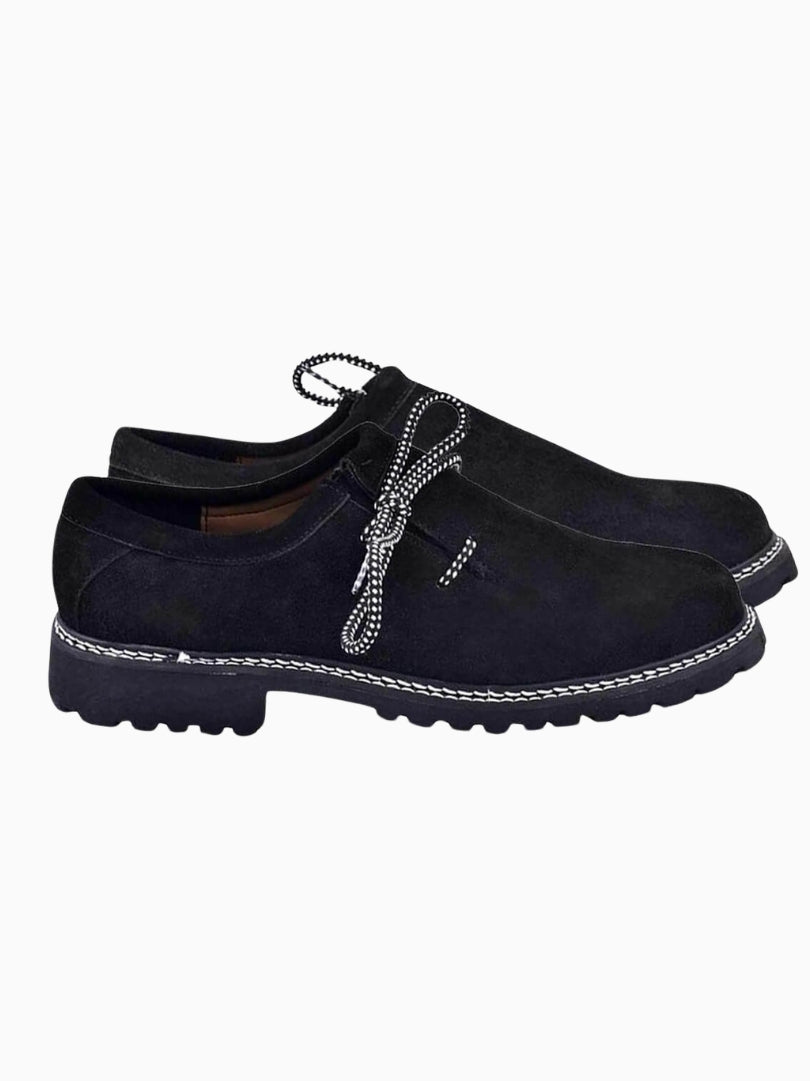 Classic black suede Lederhosen shoes with contrast stitching and durable outsole, side view.