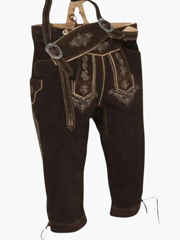Brown leather bundhosen with attached suspenders displayed at an angle, highlighting embroidered front flap and traditional design.