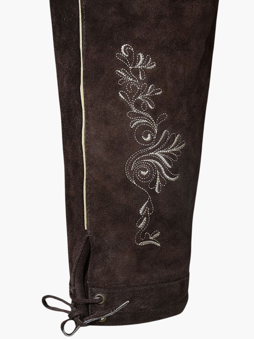 Close-up of brown bundhosen leg showing intricate floral embroidery, contrast piping, and lace-up knee hem with metal eyelets.
