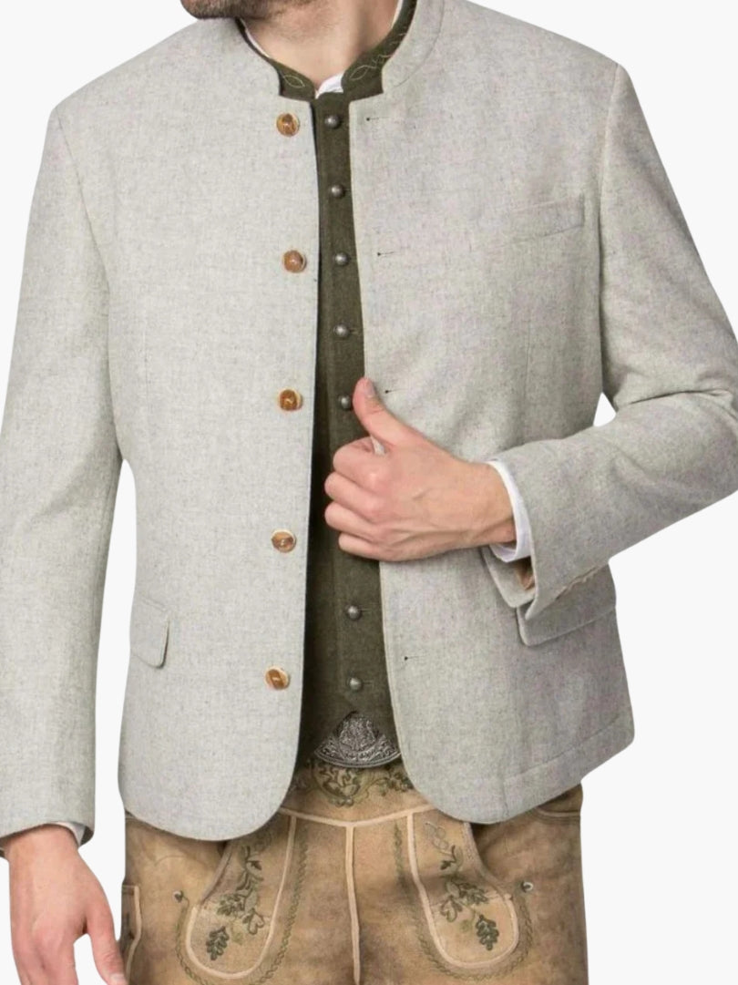 Light grey traditional Bavarian jacket layered over green vest and lederhosen, showcasing authentic Oktoberfest fashion details.