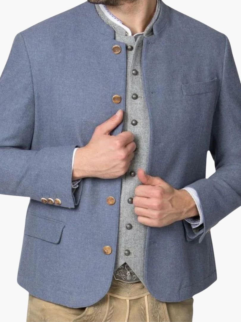 Light blue Trachten jacket worn over grey vest and lederhosen, highlighting authentic Oktoberfest layered outfit.