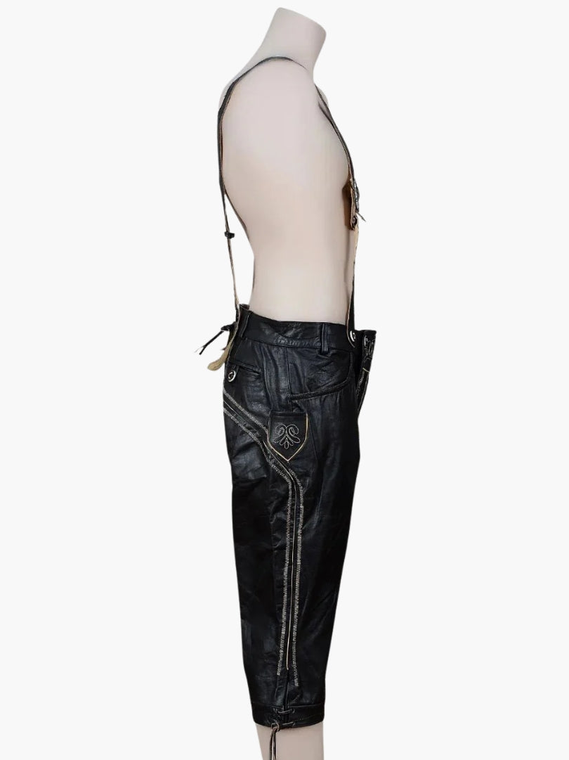 Side view of black bundhosen worn by a model, highlighting side embroidery, pocket detail, and adjustable suspenders.