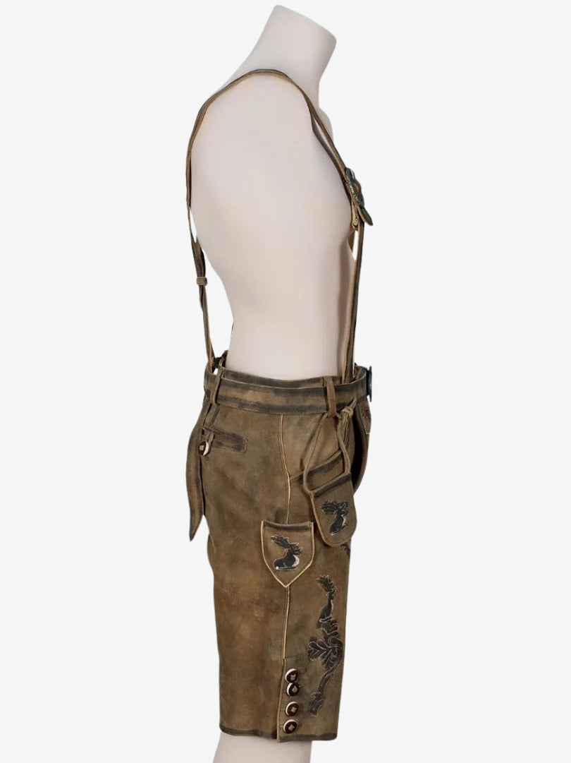 Side view of brown lederhosen showing embroidered patterns, pocket detail, and decorative buttons on the leg.