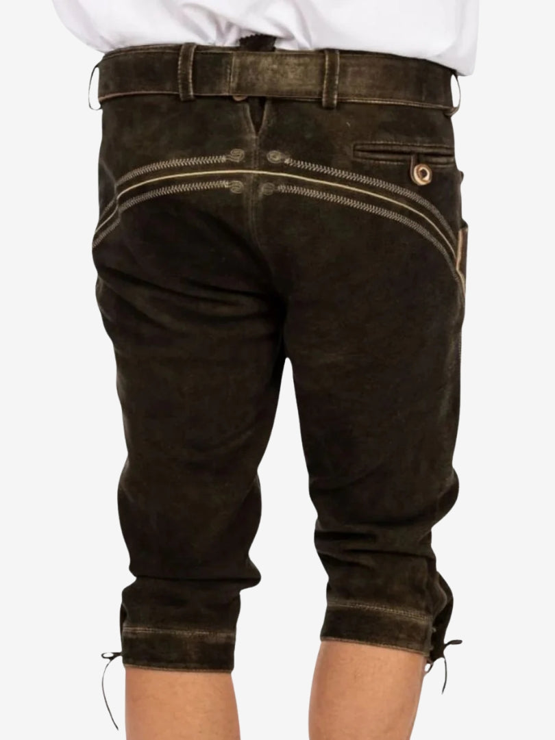 Back view of dark brown bundhosen showing rear pocket, seam detailing, and knee-length design with tie closures.