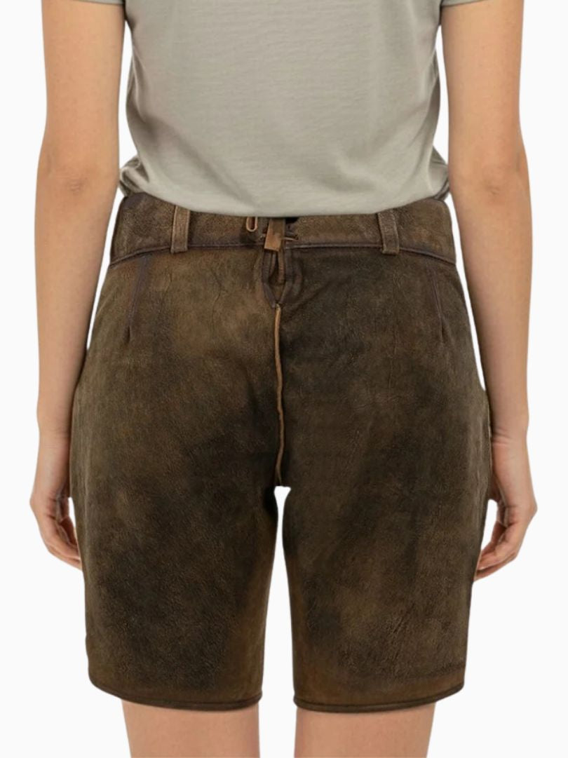 Back view of brown leather Oktoberfest lederhosen shorts worn by a person, showing a plain traditional design with belt loops, lace-up back adjustment, and a light-colored shirt tucked in.