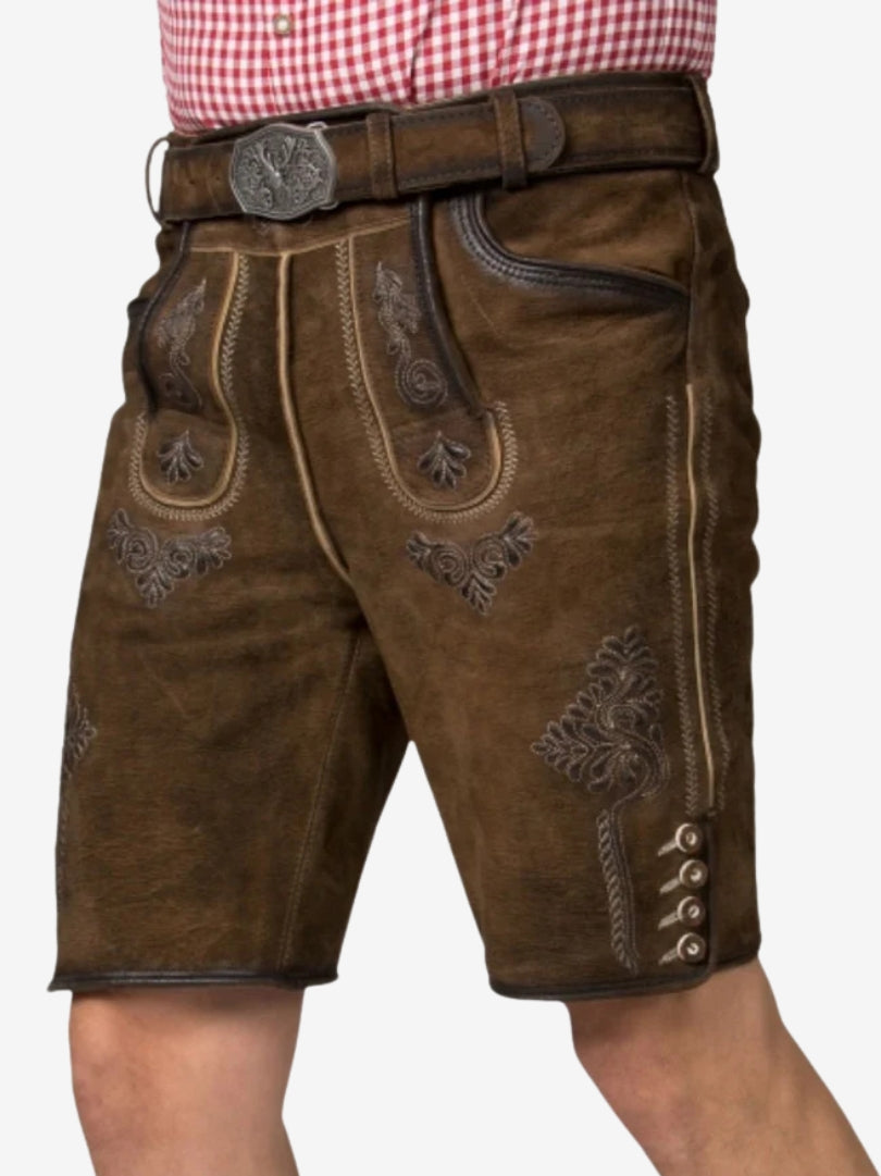 Angled view of brown lederhosen shorts showing side embroidery and button detailing.