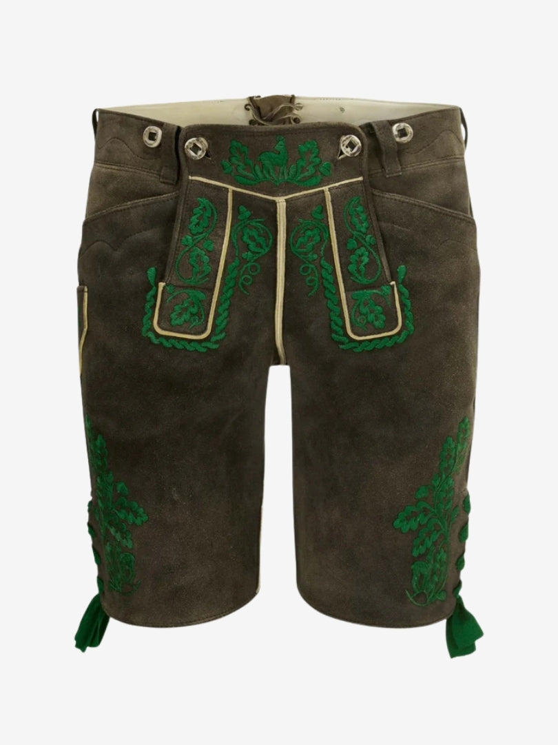 Man wearing dark olive leather lederhosen with green embroidery and a white shirt, showcasing a traditional Bavarian outfit.